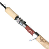 Fishing rod with wooden handle and reel on a white background